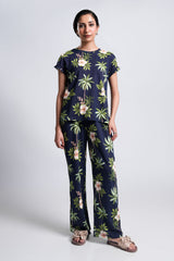 Palm – LaRosa Night Wears for Women – Cotton Summer Sets Collection | Larosawears | Shop Online – Front View.
Woman wearing a navy blue outfit with floral and palm tree patterns on a white background