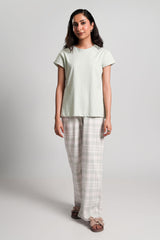 Toren – LaRosa Night Wears for Women – Cotton Summer Sets Collection | Larosawears | Shop Online – Front View.
Woman wearing a light green t-shirt and checkered pants on a white background