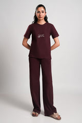 Mocha – LaRosa Night Wears for Women – Cotton Summer Sets Collection | Larosawears | Shop Online – Front View.
Woman wearing a burgundy outfit with a white logo on a plain background
