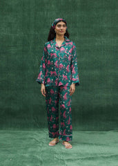 Wearing a pink silk pajama set with bold panther prints.