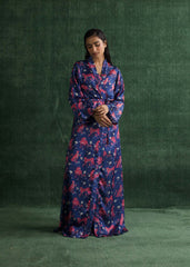 A women standing in a full-length shot, wearing a deep blue gown with vibrant pink tiger prints and a matching waist belt.